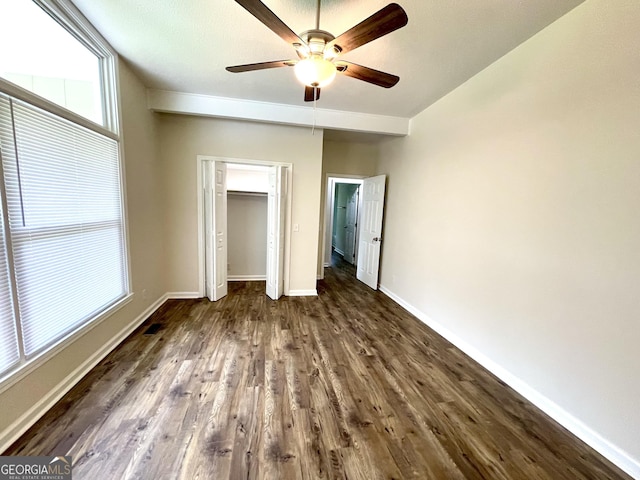 unfurnished bedroom featuring ceiling fan and dark wood-type flooring