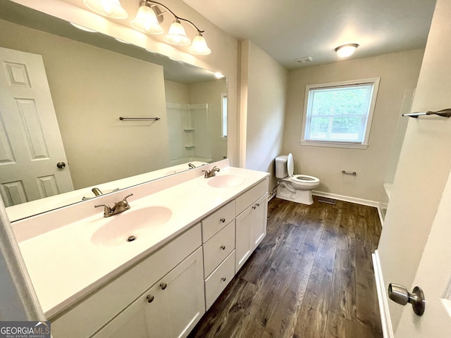 full bathroom with vanity, toilet, wood-type flooring, and washtub / shower combination