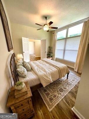 bedroom with ceiling fan and dark wood-type flooring