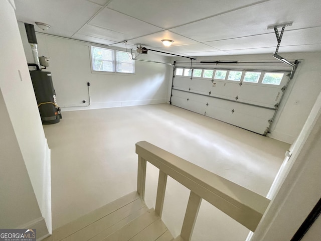 garage with water heater and a garage door opener