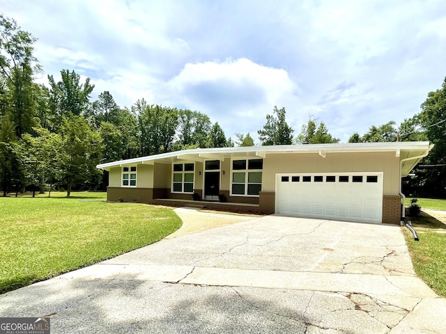 ranch-style home featuring a garage and a front lawn