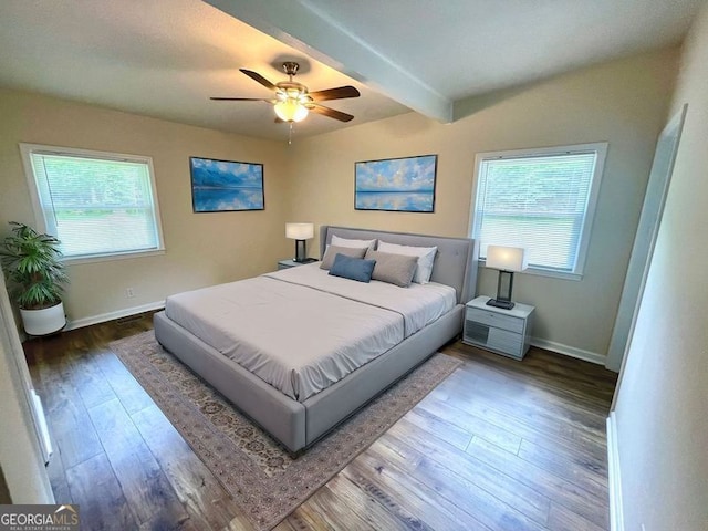 bedroom featuring hardwood / wood-style floors, ceiling fan, and beam ceiling