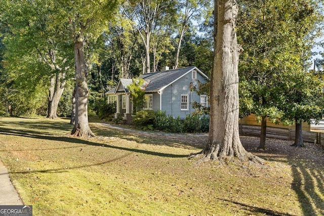 view of side of property with a lawn