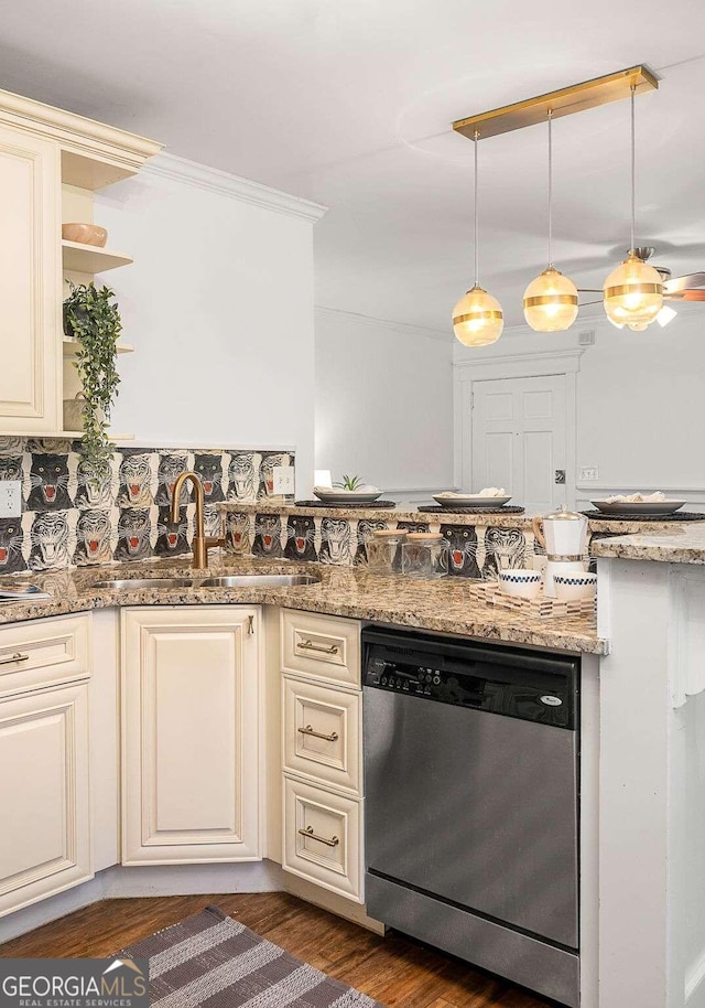 kitchen with dishwasher, dark hardwood / wood-style flooring, light stone counters, cream cabinets, and hanging light fixtures