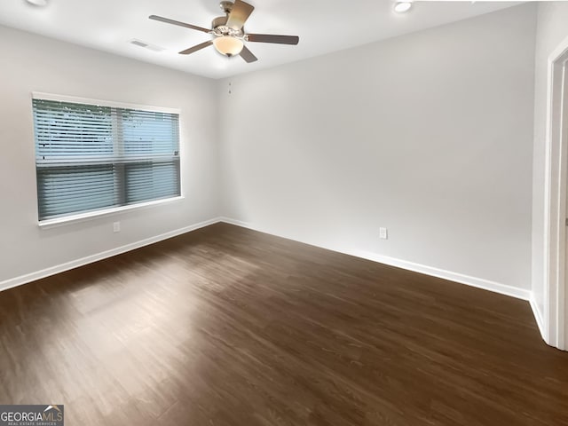 unfurnished room featuring ceiling fan and dark wood-type flooring