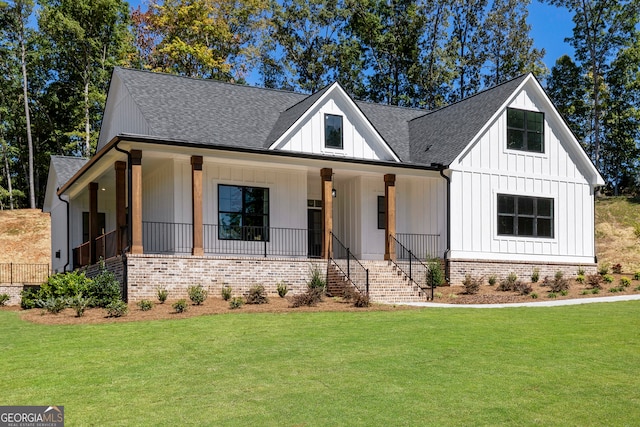 modern farmhouse with covered porch and a front lawn