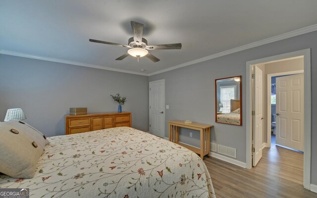 bedroom featuring ornamental molding, wood-type flooring, and ceiling fan