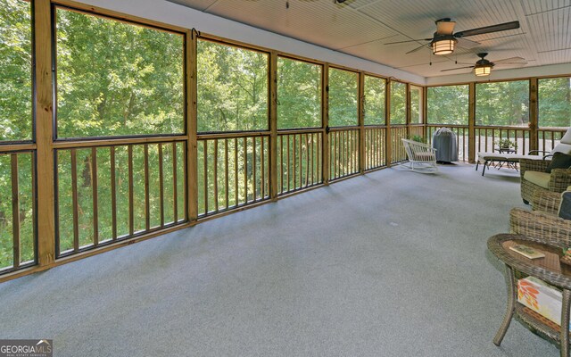 unfurnished sunroom featuring ceiling fan