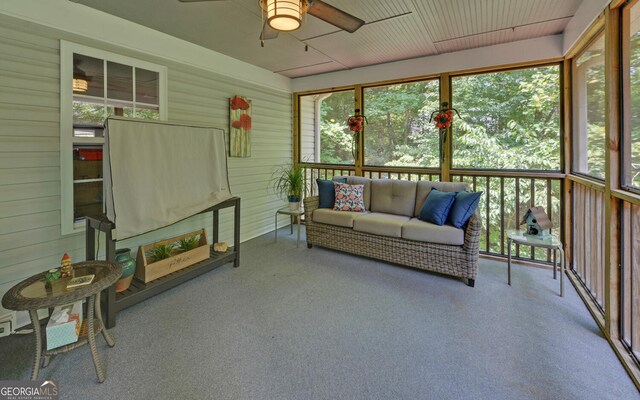 unfurnished sunroom with ceiling fan