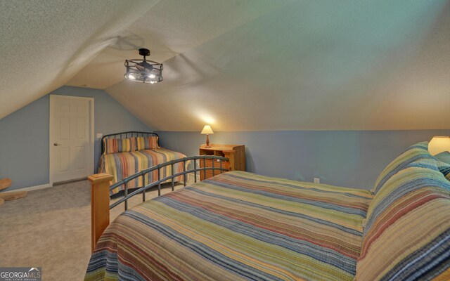 carpeted bedroom featuring a textured ceiling and lofted ceiling