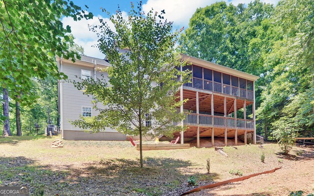 back of house featuring a wooden deck