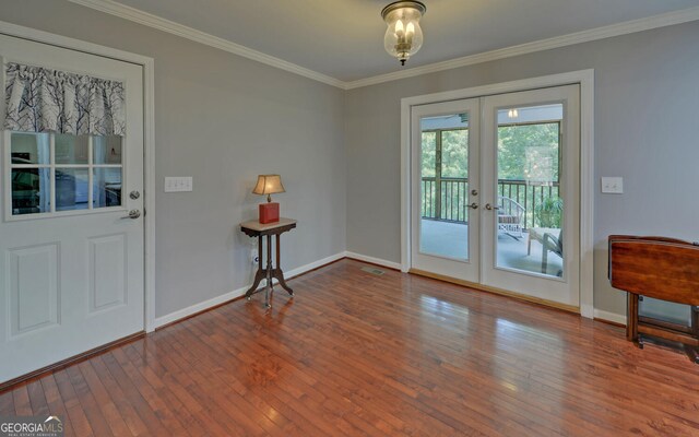 doorway featuring french doors, ornamental molding, and wood-type flooring