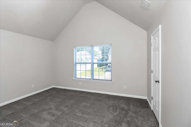 carpeted empty room featuring high vaulted ceiling