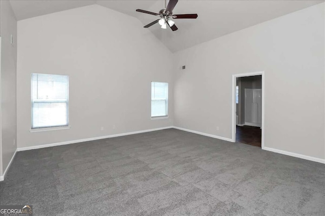 unfurnished room with dark colored carpet, high vaulted ceiling, and ceiling fan