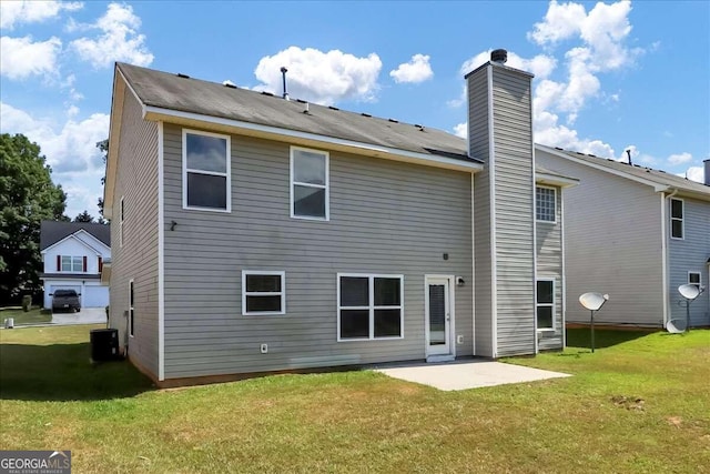 rear view of house featuring a patio, central air condition unit, and a lawn