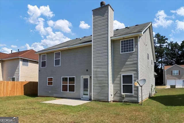 back of house with a yard and a patio