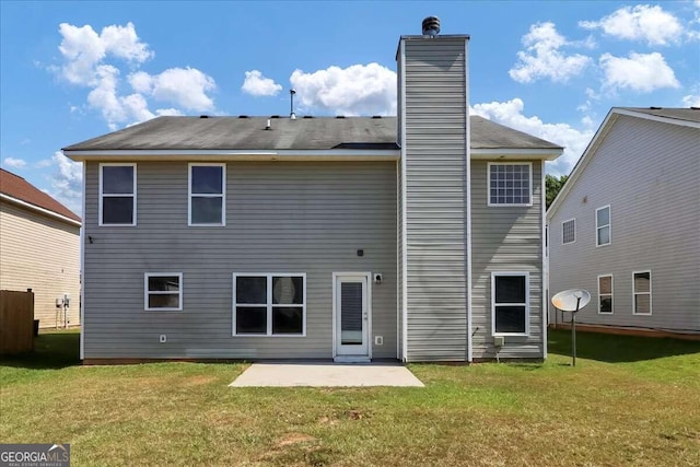 back of house featuring a patio area and a yard