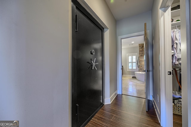 corridor with dark hardwood / wood-style flooring