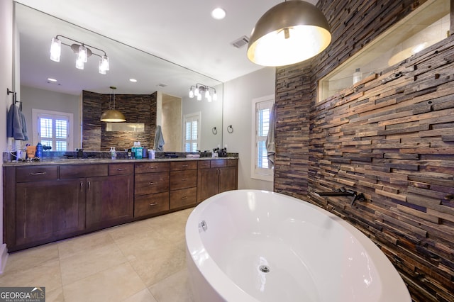 bathroom featuring vanity, a tub to relax in, and tile patterned floors