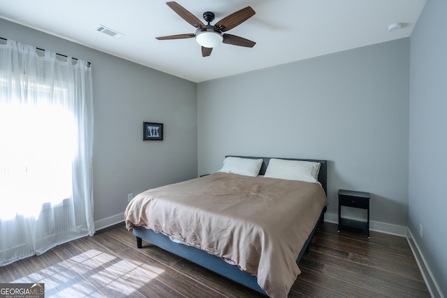 bedroom featuring ceiling fan and dark wood-type flooring