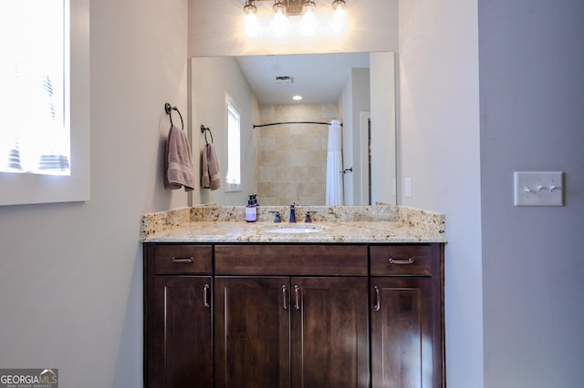 bathroom featuring a shower with curtain and vanity