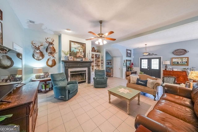 tiled living room featuring french doors and ceiling fan