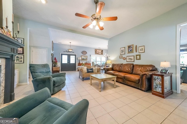 tiled living room featuring ceiling fan and french doors