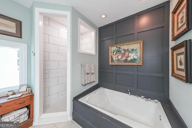 bathroom featuring tile patterned flooring, a textured ceiling, and independent shower and bath