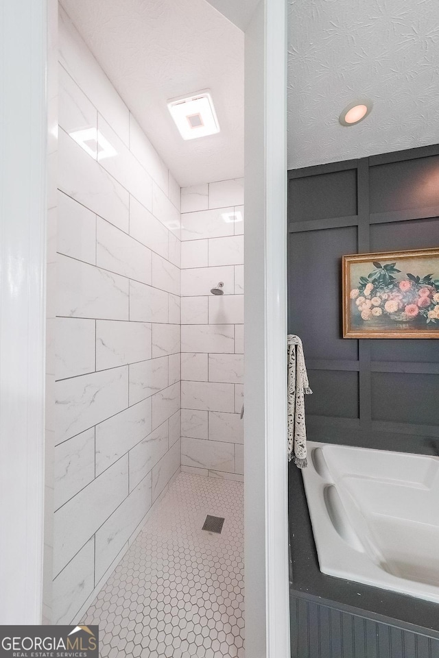 bathroom with tiled shower