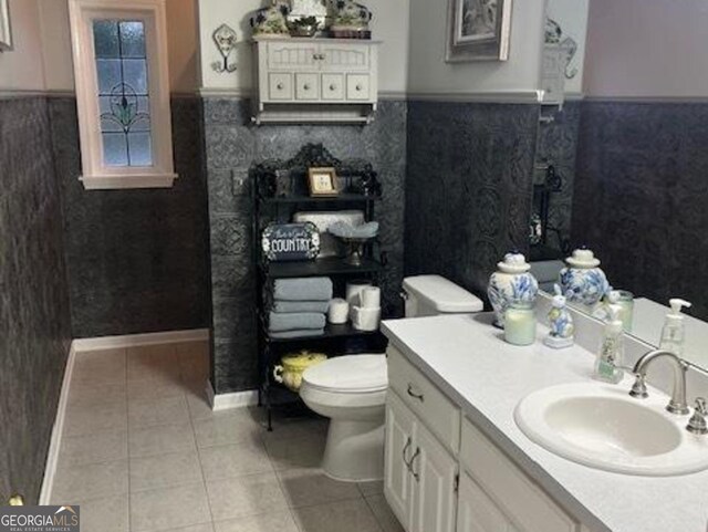 bathroom featuring toilet, vanity, and tile patterned floors