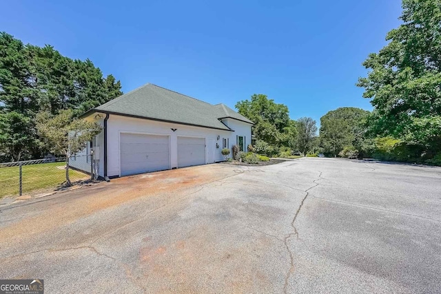 view of side of home with a garage