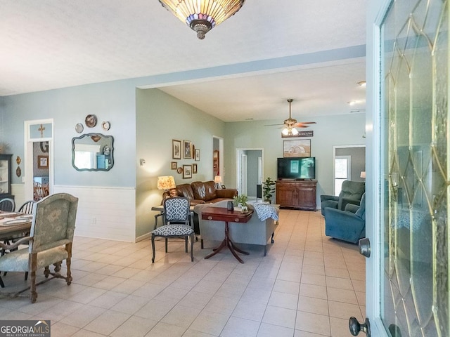 living room featuring ceiling fan and light tile patterned flooring