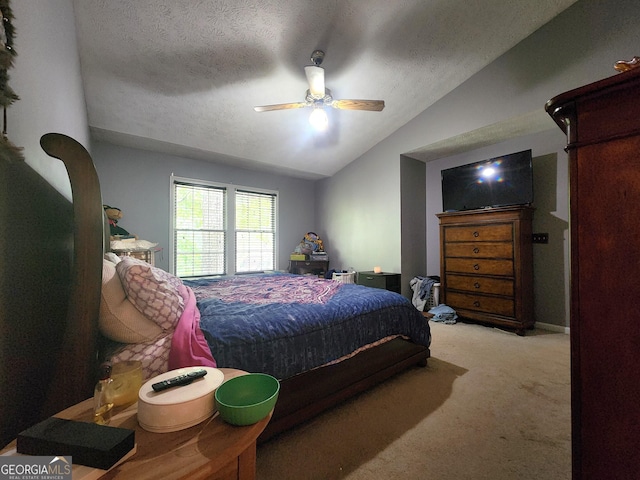 bedroom with ceiling fan, lofted ceiling, light carpet, and a textured ceiling