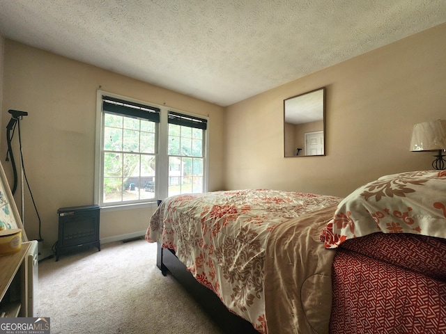 carpeted bedroom featuring a textured ceiling