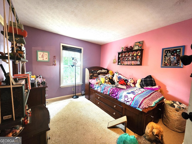 bedroom with carpet floors and a textured ceiling