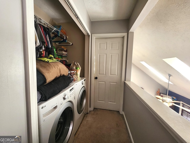 washroom featuring separate washer and dryer, a skylight, and a textured ceiling