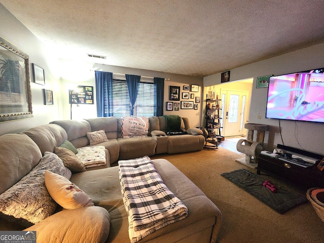 carpeted living room featuring french doors and a textured ceiling