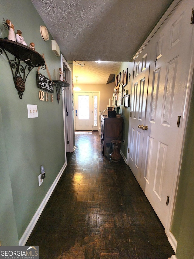 hallway with a textured ceiling