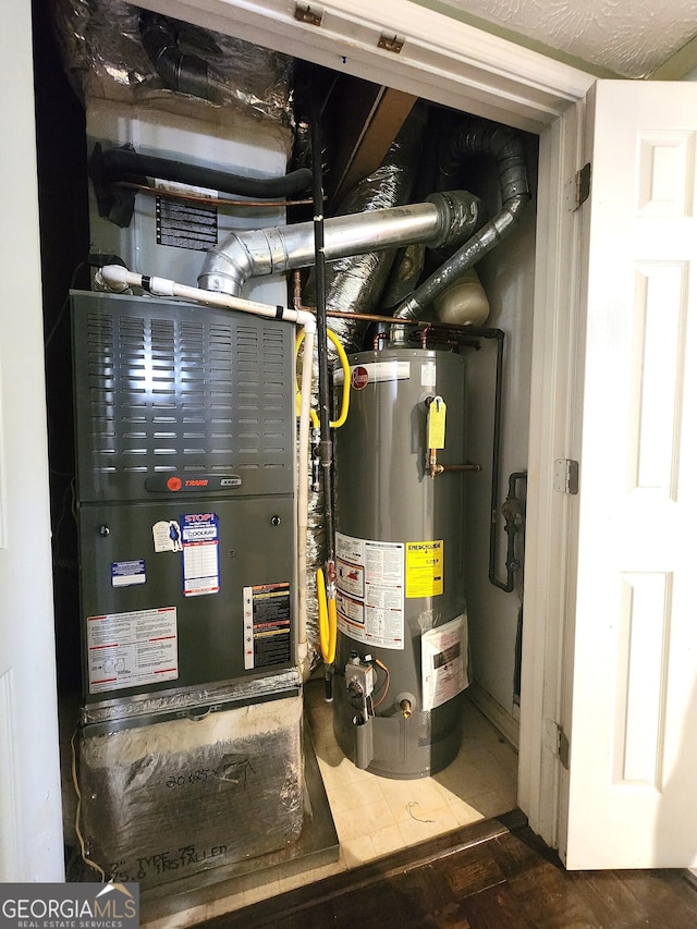 utility room featuring gas water heater