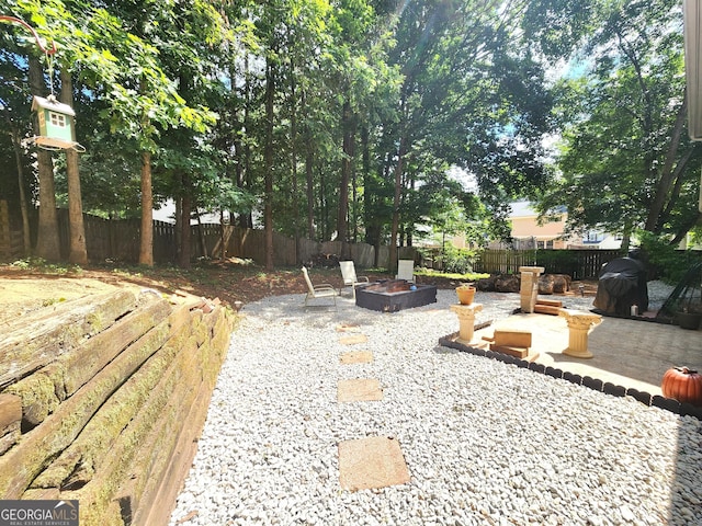 view of yard featuring a patio area and a fire pit