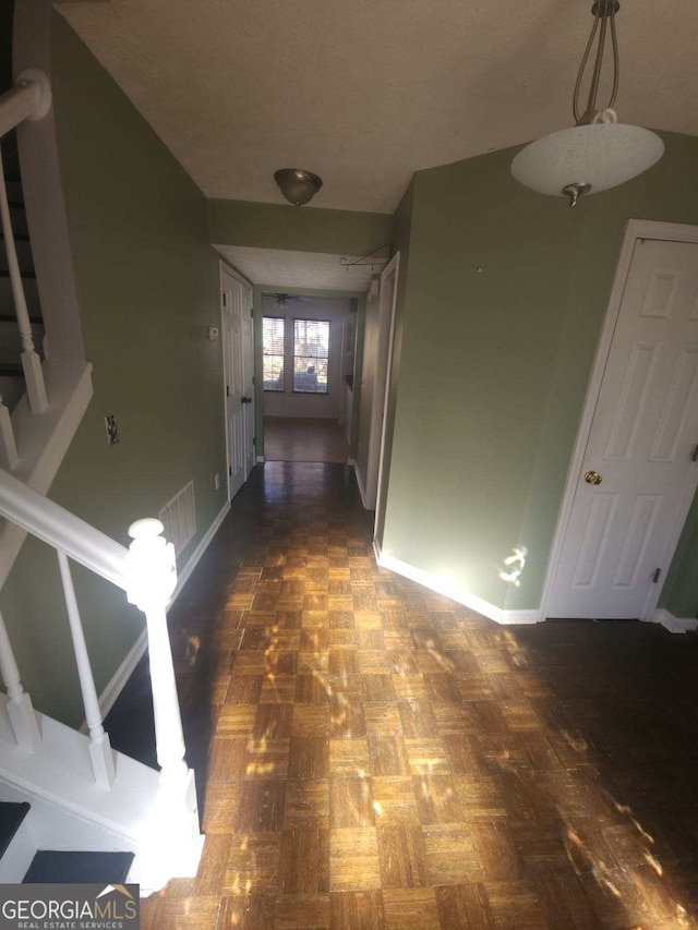 hall with dark parquet flooring