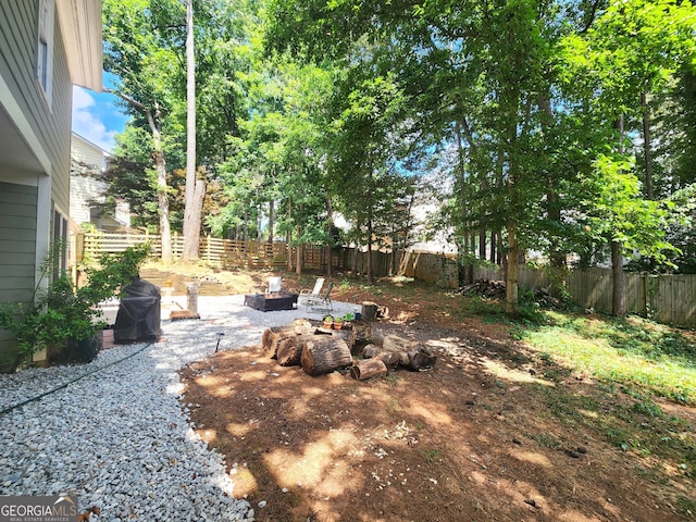 view of yard with an outdoor fire pit