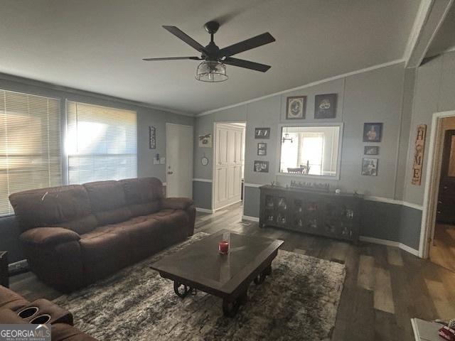 living room featuring vaulted ceiling, crown molding, ceiling fan, and dark hardwood / wood-style flooring