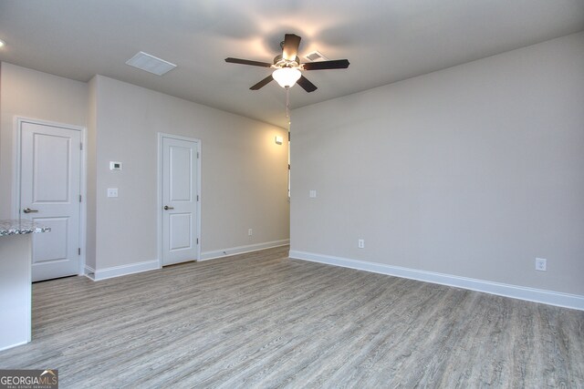 unfurnished room with light wood-type flooring and ceiling fan