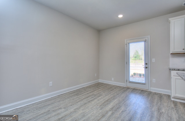 unfurnished dining area featuring light hardwood / wood-style floors