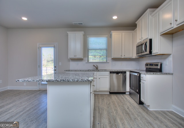 kitchen featuring white cabinets, a wealth of natural light, and appliances with stainless steel finishes