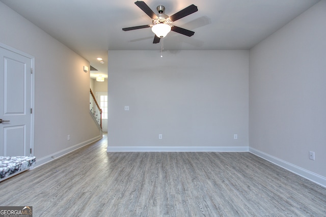 spare room featuring ceiling fan and light wood-type flooring