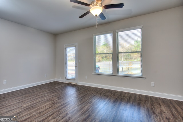 spare room with ceiling fan and dark hardwood / wood-style floors