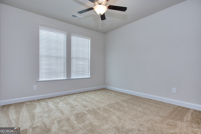 carpeted empty room featuring ceiling fan and a healthy amount of sunlight