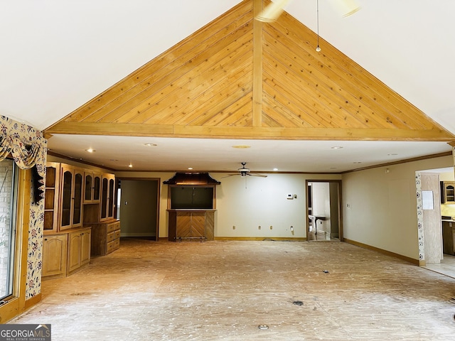 unfurnished living room featuring vaulted ceiling and ceiling fan